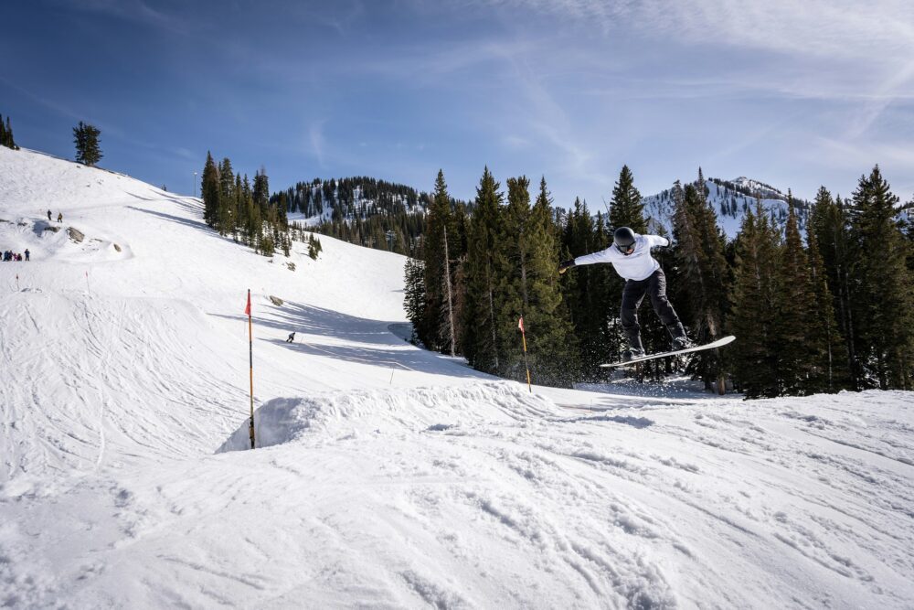 snowboarder jumping on slopes