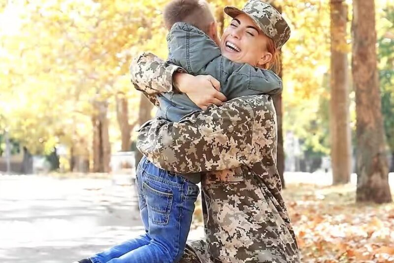 Female veteran greeting child