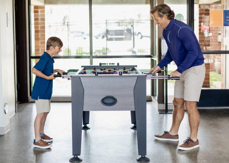 game room dad and son playing